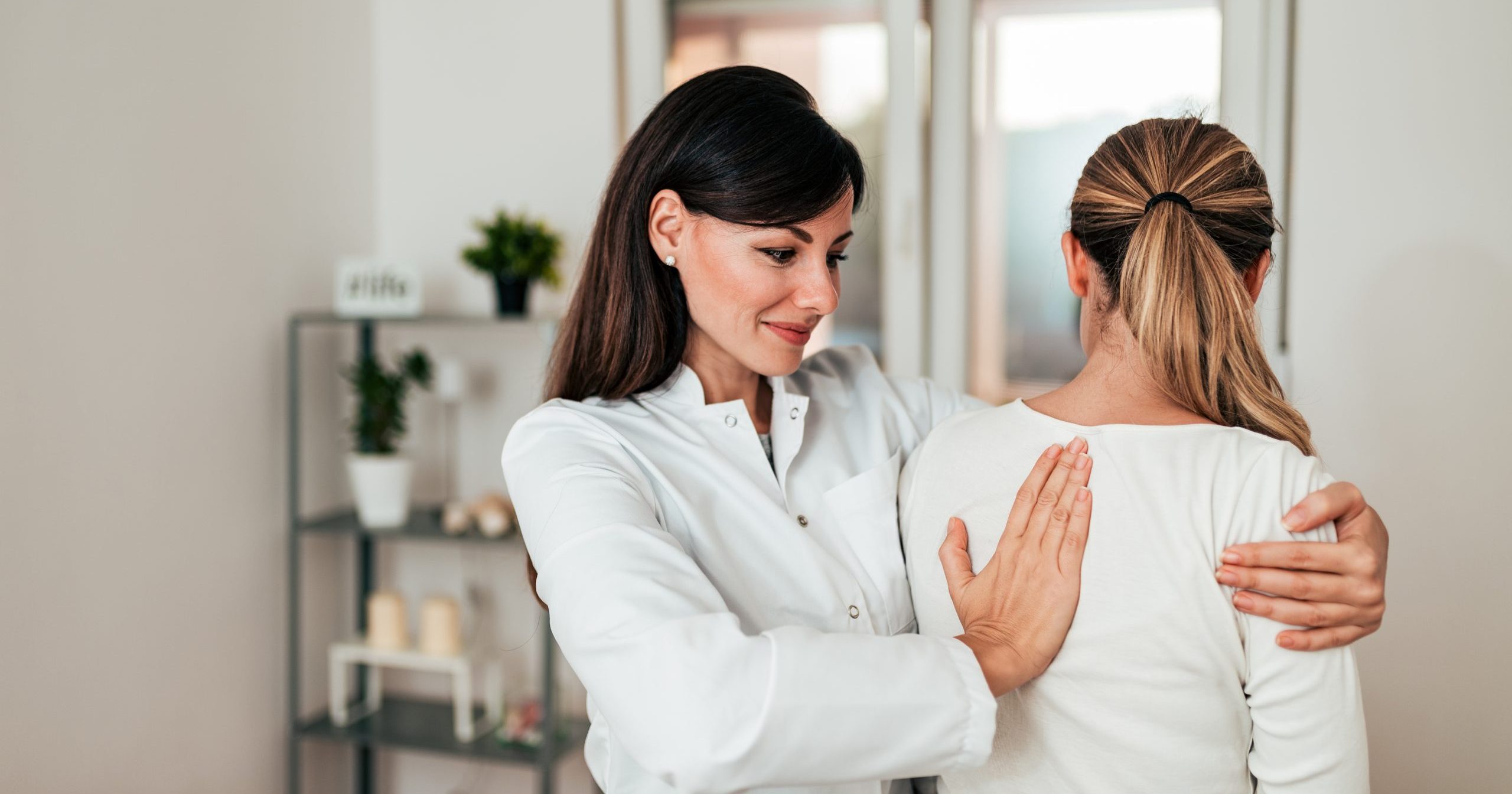 Female doctor examining a female patient.